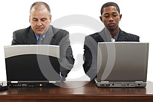 Businessmen At Desk With Laptops