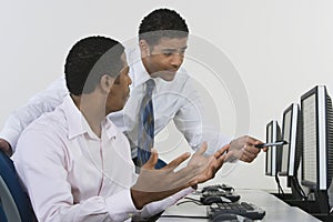 Businessmen Discussing In Computer Lab