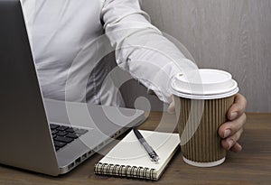 Businessmen drinking coffee from paper cups