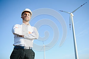 Businessmen engineering standing handsome smile front of turbine looking away