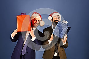 Businessmen with excited faces hold red and blue present boxes