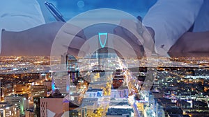 Businessmen hands signing documents on Riyadh skyline city scape background