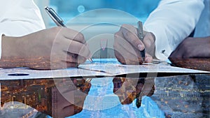 Businessmen hands signing documents on Riyadh skyline city scape background