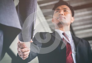 Businessmen are handshake agree to join the business.Focus at ha