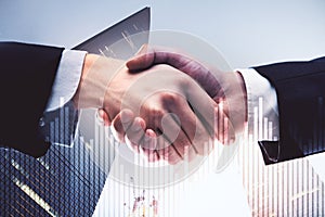 Businessmen handshake and business chart