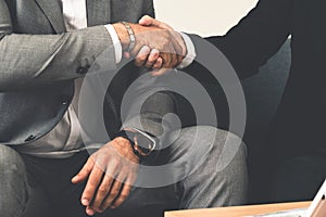 Businessmen handshake business deal in office
