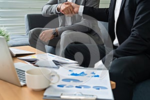 Businessmen handshake business deal in office.