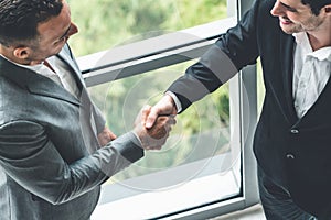 Businessmen handshake business deal in office.