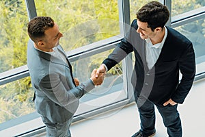Businessmen handshake business deal in office. uds