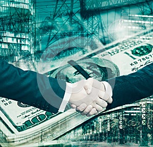 Businessmen handshake on dollar background