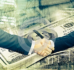 Businessmen handshake on dollar background