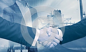 Businessmen handshake on industrial background