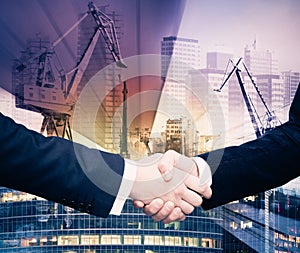 Businessmen handshake on industrial background