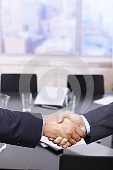 Businessmen handshake over table