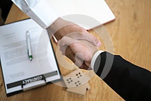 Businessmen handshake to invest and share profits in building and residential projects. Have a contract document that has legal