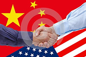 Businessmen handshaking on Usa or American and China flags merged politic and economic relationships concept