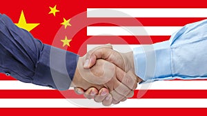 Businessmen handshaking on Usa or American and China flags merged relationship concept