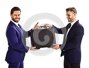 Businessmen with happy faces hold black briefcase.