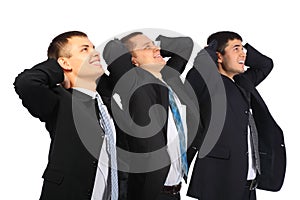 Businessmen hold hands behin head and look upwards