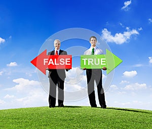 Businessmen Holding Arrows for False and True