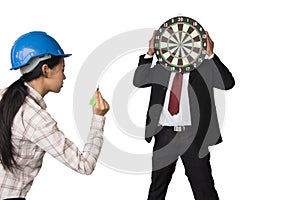 Businessmen holding a dart board and Engineering girl prepare darts