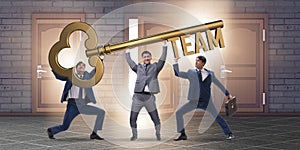 The businessmen holding giant key in team concept