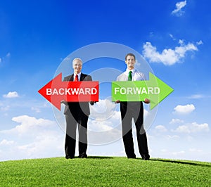 Businessmen Holding Word Backward and Forward