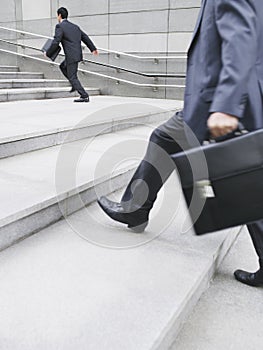 Businessmen Hurrying Up Steps Outdoors