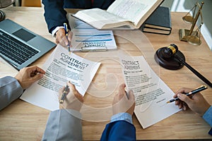 Businessmen and investors discussed joint venture within the legal counsel office and agreed to sign a contract in front of the photo