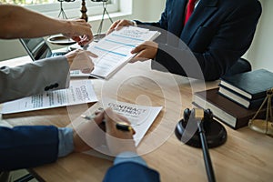 Businessmen and investors discussed joint venture within the legal counsel office and agreed to sign a contract in front of the photo