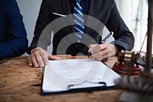 Businessmen and investors discussed joint venture within the legal counsel office and agreed to sign a contract in front of the photo