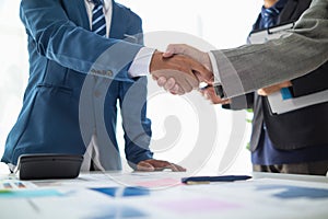 Businessmen and investors shake hands after attending meeting with advisory team after receiving advice from advisory team about