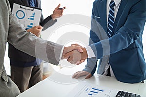 Businessmen and investors shake hands after attending meeting with advisory team after receiving advice from advisory team about