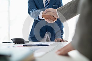 Businessmen and investors shake hands after attending meeting with advisory team after receiving advice from advisory team about