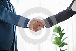 Businessmen and investors shake hands after attending meeting with advisory team after receiving advice from advisory team about