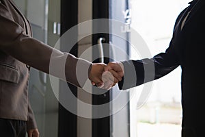 Businessmen and investors shake hands after attending meeting with advisory team after receiving advice from advisory team about