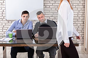 Businessmen Looking At Woman