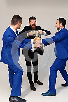 Businessmen with mad faces in formal suits on grey background.