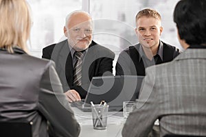 Businessmen meeting with businesswomen photo
