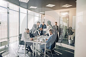 Businessmen in meeting room View through glass. Business and entrepreneurship.