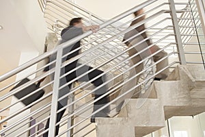 Businessmen Moving Upstairs In Office