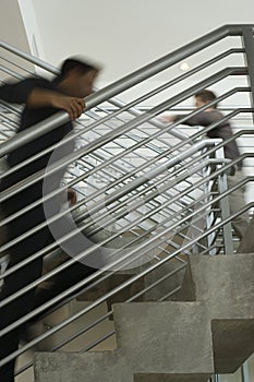 Businessmen Moving Upstairs In Office