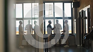 businessmen with name tags talking at office