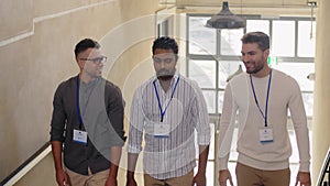 Businessmen with name tags walking upstairs