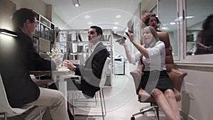 Businessmen negotiating while women having fun