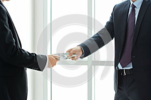 Businessmen passing money