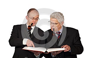 Businessmen with pipes reading a book