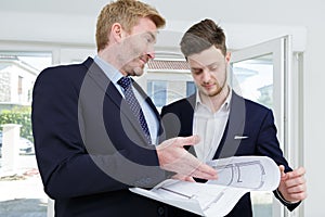 businessmen planning on paper