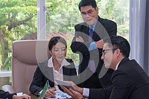 Businessmen pointing way to stranger man who was meet on the street.Young businessman wearing a suit and sunglasses with