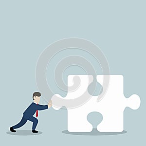 Businessmen pushing jigsaw piece